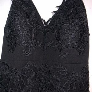 Long black dress with lace appearance and slit